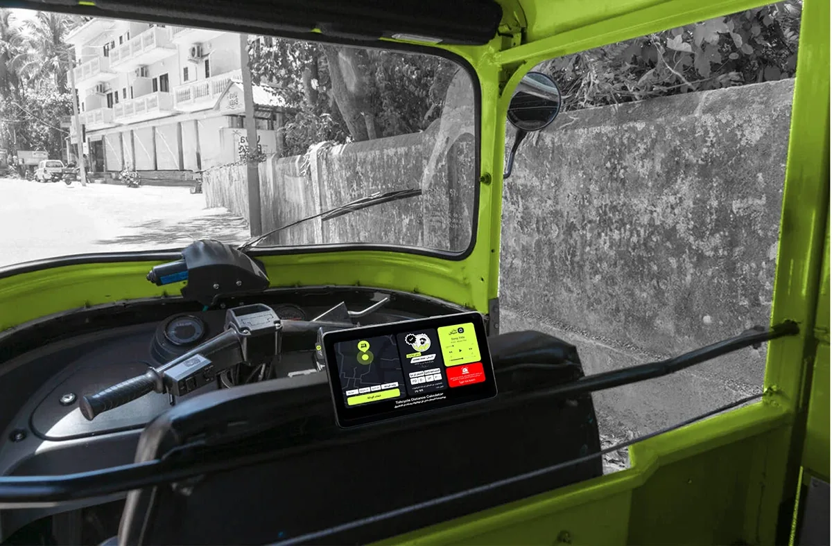 The Tukcycle device fitted on the dashboard of a lime-green tuk-tuk